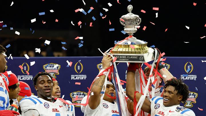 Jan 1, 2026; New Orleans, LA, USA; Mississippi Rebels quarterback Trinidad Chambliss (6) and running back Kewan Lacy (5) lift the trophy after the 2026 Sugar Bowl and quarterfinal game of the College Football Playoff against the Georgia Bulldogs at Caesars Superdome. Mandatory Credit: Amber Searls-Imagn Images Jan 1, 2026; New Orleans, LA, USA; Mississippi Rebels quarterback Trinidad Chambliss (6) and running back Kewan Lacy (5) lift the trophy after the 2026 Sugar Bowl and quarterfinal game of the College Football Playoff against the Georgia Bulldogs at Caesars Superdome. Mandatory Credit: Amber Searls-Imagn Images