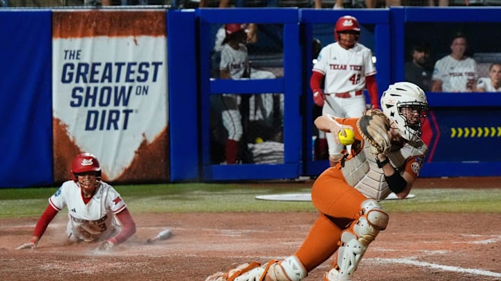 Texas Tech utility Makayla Garcia (3) watches Texas catcher Reese Atwood (14) after Garcia scored in Game 2 of the Women's College World Series championship series between the Texas Longhorns at Texas Tech Red Raiders at Devon Park in Oklahoma City, Thursday, June 5, 2025. Texas Tech won 4-3.