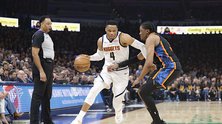 May 5, 2025; Oklahoma City, Oklahoma, USA; Denver Nuggets guard Russell Westbrook (4) drives against Oklahoma City Thunder forward Jalen Williams (8) during the second quarter during game one of the second round for the 2025 NBA Playoffs at Paycom Center. Mandatory Credit: Alonzo Adams-Imagn Images