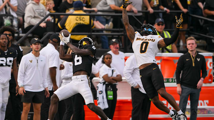 Oct 25, 2025; Nashville, Tennessee, USA;  Vanderbilt Commodores wide receiver Tre Richardson (6) makes a catch over Missouri Tigers cornerback Stephen Hall (0) during the first half at FirstBank Stadium. Mandatory Credit: Steve Roberts-Imagn Images