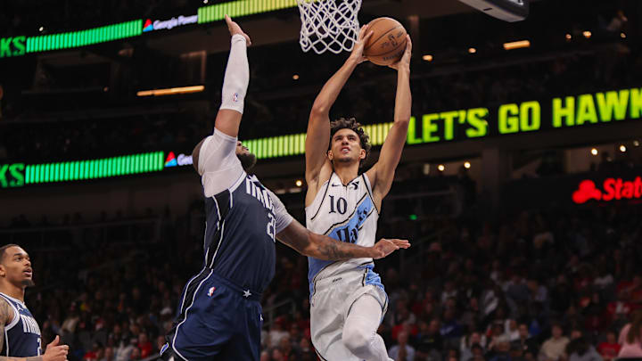 Nov 25, 2024; Atlanta, Georgia, USA; Atlanta Hawks forward Zaccharie Risacher (10) is defended by Dallas Mavericks center Daniel Gafford (21) in the third quarter at State Farm Arena. Mandatory Credit: Brett Davis-Imagn Images
