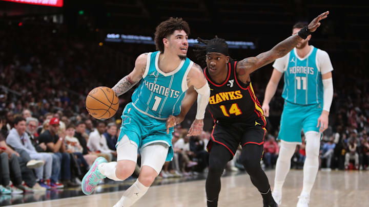 Mar 12, 2025; Atlanta, Georgia, USA; Charlotte Hornets guard LaMelo Ball (1) works past Atlanta Hawks guard Terance Mann (14) during the second half at State Farm Arena. Mandatory Credit: Mady Mertens-Imagn Images