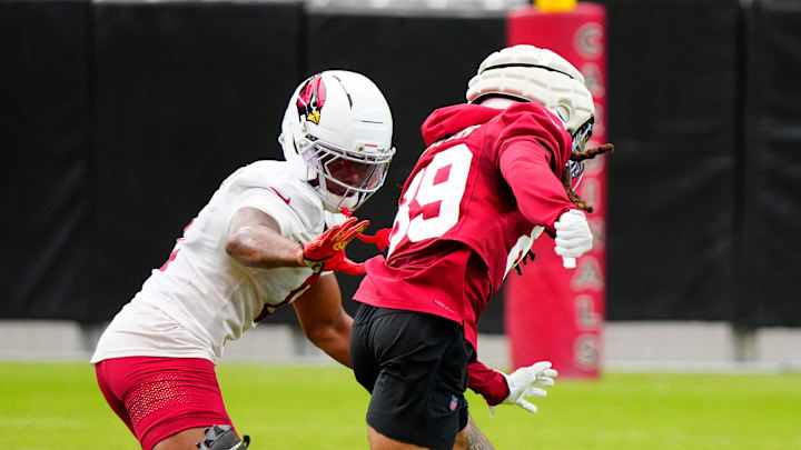 Cardinals cornerback Will Johnson (0) defends wide out Xavier Weaver (89) 