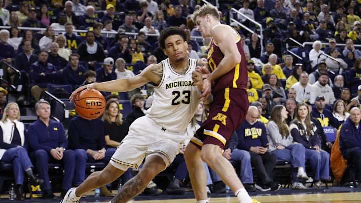Feb 24, 2026; Ann Arbor, Michigan, USA; Michigan Wolverines forward Yaxel Lendeborg (23) is defended by Minnesota Golden Gophers guard Cade Tyson (10) in the first half at Crisler Center. Mandatory Credit: Rick Osentoski-Imagn Images