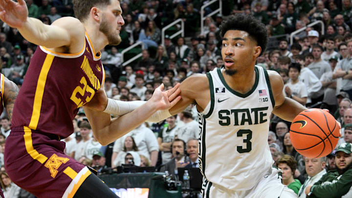 Jan 28, 2025; East Lansing, Michigan, USA;  Michigan State Spartans guard Jaden Akins (3) works around Minnesota Golden Gophers forward Parker Fox (23) during the second half at Jack Breslin Student Events Center. Mandatory Credit: Dale Young-Imagn Images