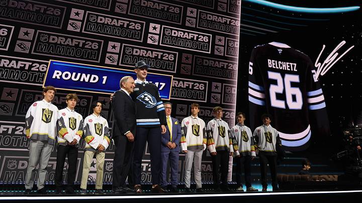 Jun 26, 2026; Buffalo, New York, USA; Ethan Belchetz reacts beside NHL commissioner Gary Bettman after being selected with the seventeenth pick in the first round of the 2026 NHL Draft by the Utah Mammoth at KeyBank Center. Mandatory Credit: Timothy T. Ludwig-Imagn Images