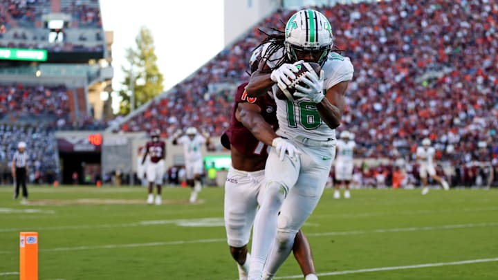 Sep 7, 2024; Blacksburg, Virginia, USA; Marshall Thundering Herd wide receiver Christian Fitzpatrick (16) catches a touchdown pass against Virginia Tech Hokies safety Mose Phillips III (18) during the second quarter at Lane Stadium. Mandatory Credit: Peter Casey-Imagn Images