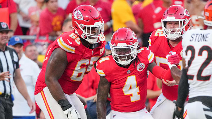 Sep 15, 2024; Kansas City, Missouri, USA; Kansas City Chiefs wide receiver Rashee Rice (4) is helped up by guard Trey Smith (65) against the Cincinnati Bengals after a penalty during the second half at GEHA Field at Arrowhead Stadium. Mandatory Credit: Denny Medley-Imagn Images