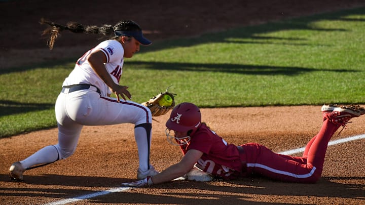 Feb 2, 2024; Tuscaloosa, Alabama, USA; Arizona third baseman Blaise Biringer takes a throw too late to get Alabama base runner Marlie Giles as she goes first to third on a hit as Alabama played Arizona Saturday at Rhoads Stadium.