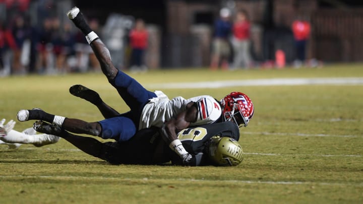 Toombs County cornerback Lagonza Hayward (2) tackles Thomson wide receiver Cervutes Felts (9) during the Thomson and Toombs County playoff game at The Brickyard in Thomson, Ga., on Friday, Nov. 17, 2023. Toombs County defeated Thomson 41-30.