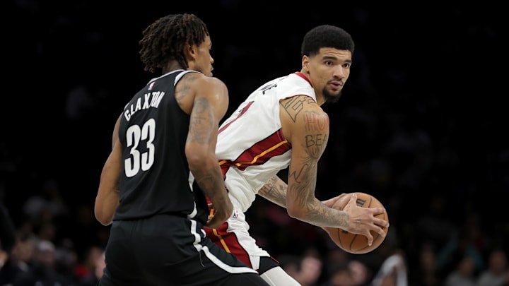 Dec 18, 2025; Brooklyn, New York, USA; Miami Heat center Kel'El Ware (7) controls the ball against Brooklyn Nets center Nic Claxton (33) during the fourth quarter at Barclays Center. Mandatory Credit: Brad Penner-Imagn Images