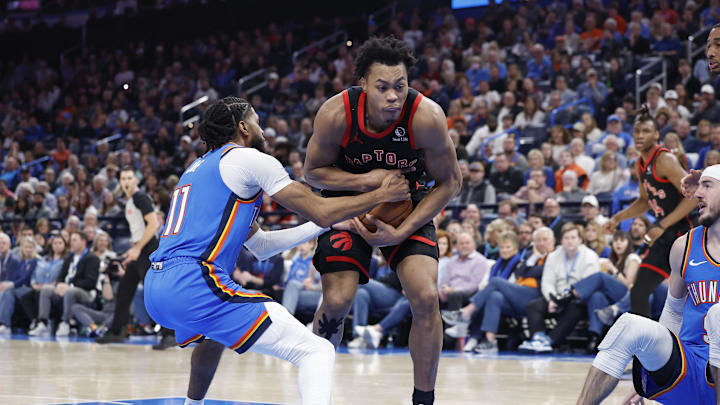 Feb 7, 2025; Oklahoma City, Oklahoma, USA; Toronto Raptors forward Scottie Barnes (4) is defended by Oklahoma City Thunder guard Isaiah Joe (11) on a drive to the basket during the second half at Paycom Center. Mandatory Credit: Alonzo Adams-Imagn Images