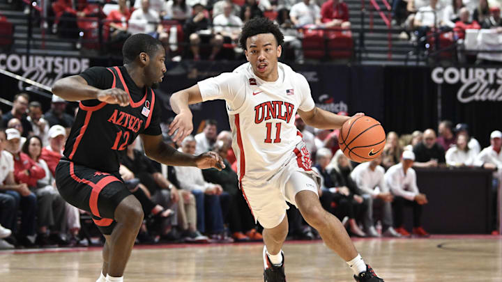 Mar 5, 2024; Las Vegas, Nevada, USA; UNLV Rebels guard Dedan Thomas Jr. (11) drives past San Diego State Aztecs guard Darrion Trammell (12) in the first half at Thomas & Mack Center. Mandatory Credit: Candice Ward-Imagn Images