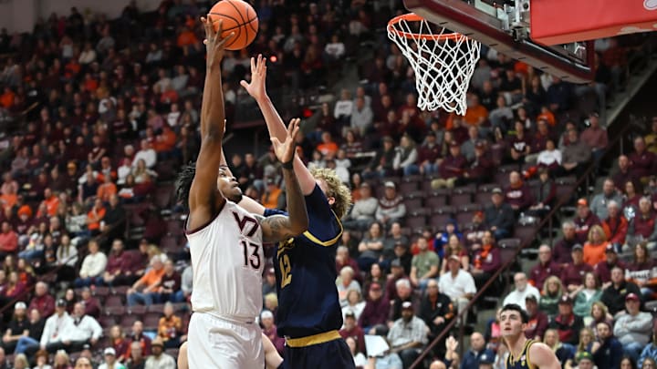 Jan 17, 2026; Blacksburg, Virginia, USA; Virginia Tech Hokies forward Amani Hansberry (13) shoots a shot as Notre Dame Fighting Irish forward Garrett Sundra (12) defends during the first half at Cassell Coliseum. Mandatory Credit: Brian Bishop-Imagn Images