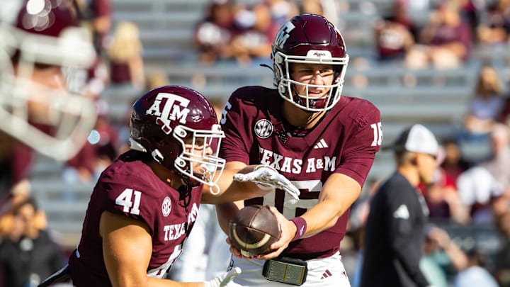 Nov 22, 2025; College Station, Texas, USA; Texas A&M Aggies quarterback Miles O'Neill (16) hands the ball off Texas A&M Aggies running back AJ DiNota (41) before a game against the Samford Bulldogs at Kyle Field. Mandatory Credit: Joseph Buvid-Imagn Images