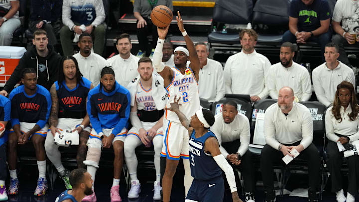 May 26, 2025; Minneapolis, Minnesota, USA; Oklahoma City Thunder guard Shai Gilgeous-Alexander (2) shoots the ball against Minnesota Timberwolves forward Jaden McDaniels (3) in the second half during game four of the western conference finals for the 2025 NBA Playoffs at Target Center. Mandatory Credit: Jesse Johnson-Imagn Images