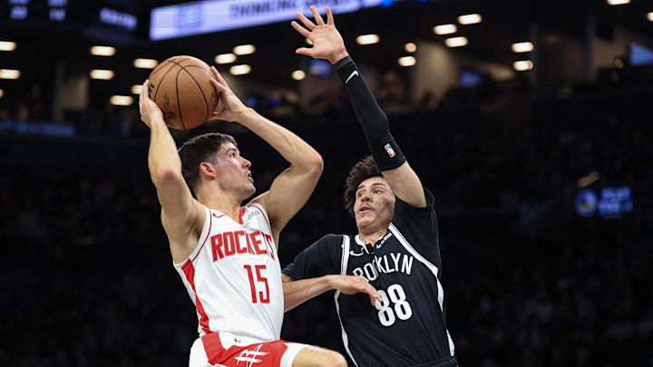 Jan 1, 2026; Brooklyn, New York, USA; Houston Rockets guard Reed Sheppard (15) goes to the basket against Brooklyn Nets guard Nolan Traore (88) during the second half at Barclays Center. Mandatory Credit: Vincent Carchietta-Imagn Images