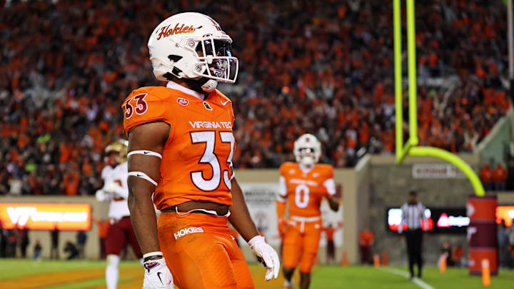 Oct 17, 2024; Blacksburg, Virginia, USA; Virginia Tech Hokies running back Bhayshul Tuten (33) celebrates after scoring a touchdown during the second quarter against the Boston College Eagles at Lane Stadium. Mandatory Credit: Peter Casey-Imagn Images