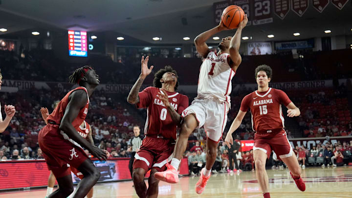 Oklahoma guard Xzayvier Brown (1) goes up for a basket as Alabama's Taylor Bol Bowen (7), Labaron Philon (0) and Noah Williamson (15) defend in the first half of the men's college basketball game between the University of Oklahoma Sooners and the Alabama Crimson Tide, Saturday Jan. 17, 2026.