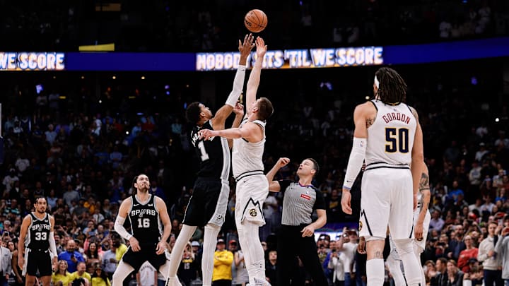 Apr 2, 2024; Denver, Colorado, USA; San Antonio Spurs center Victor Wembanyama (1) and Denver Nuggets center Nikola Jokic (15) tip off as forward Cedi Osman (16) and forward Aaron Gordon (50) look on in the first quarter at Ball Arena. 