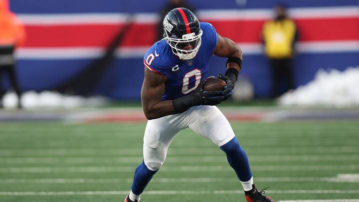 Dec 14, 2025; East Rutherford, New Jersey, USA; New York Giants linebacker Brian Burns (0) runs the ball during the fourth quarter against the Washington Commanders at MetLife Stadium.