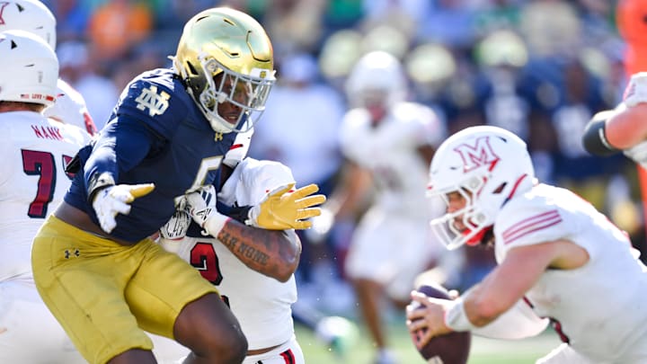Sep 21, 2024; South Bend, Indiana, USA; Notre Dame Fighting Irish defenisve lineman Boubacar Traore (5) pressures Miami Redhawks quarterback Brett Gabbert (5) in the second quarter at Notre Dame Stadium. Mandatory Credit: Matt Cashore-Imagn Images