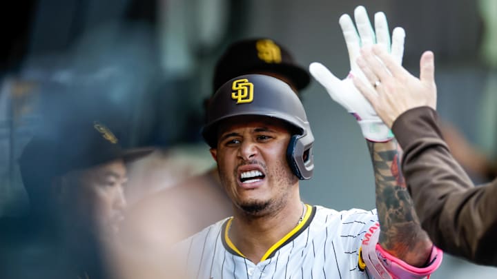 Sep 13, 2025; San Diego, California, USA; San Diego Padres third baseman Manny Machado (13) celebrates in the dugout after hitting a one run home run during the third inning against the Colorado Rockies at Petco Park. Mandatory Credit: David Frerker-Imagn Images