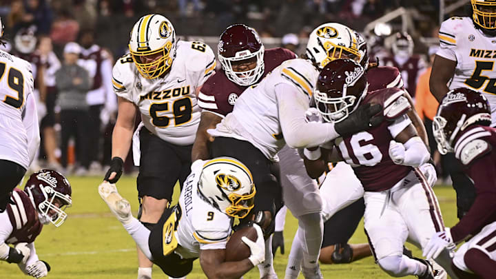 Nov 23, 2024; Starkville, Mississippi, USA; Missouri Tigers running back Marcus Carroll (9) dives for extra yardage against the Mississippi State Bulldogs during the fourth quarter at Davis Wade Stadium at Scott Field. Mandatory Credit: Matt Bush-Imagn Images Nov 23, 2024; Starkville, Mississippi, USA; Missouri Tigers running back Marcus Carroll (9) dives for extra yardage against the Mississippi State Bulldogs during the fourth quarter at Davis Wade Stadium at Scott Field. Mandatory Credit: Matt Bush-Imagn Images