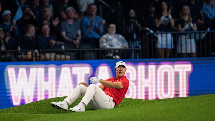 Tom Kim of Jupiter Links GC lays on the green after his chip shot just missed the cup during a TGL match against Boston Common.
