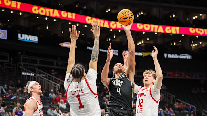 Mar 11, 2025; Kansas City, MO, USA; UCF Knights guard Keyshawn Hall (4) shoots the ball over Utah Utes guard Miro Little (1) during the second half at T-Mobile Center. Mandatory Credit: William Purnell-Imagn Images