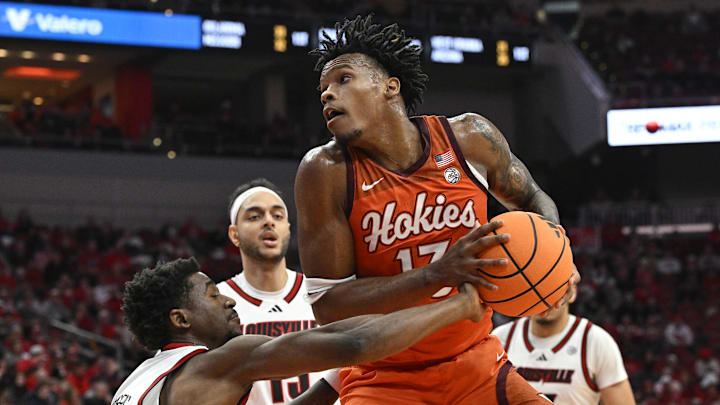 Jan 24, 2026; Louisville, Kentucky, USA;  Louisville Cardinals guard Kobe Rodgers (11) knocks the ball away from Virginia Tech Hokies forward Amani Hansberry (13) during the first half at KFC Yum! Center. Mandatory Credit: Jamie Rhodes-Imagn Images