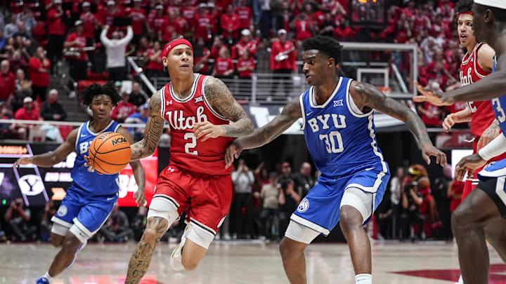 Utah Runnin' Utes guard Terrence Brown (2) drives while being defended by BYU Cougars forward Kennard Davis Jr. (30) during the second half at Jon M. Huntsman Center. Utah Runnin' Utes guard Terrence Brown (2) drives while being defended by BYU Cougars forward Kennard Davis Jr. (30) during the second half at Jon M. Huntsman Center.
