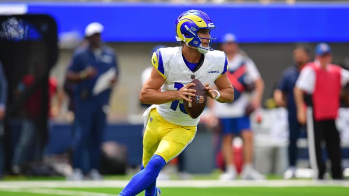 Aug 11, 2024; Inglewood, California, USA; Los Angeles Rams quarterback Stetson Bennett (13) moves out to pass against the Dallas Cowboys during the first half at SoFi Stadium. Mandatory Credit: Gary A. Vasquez-USA TODAY Sports