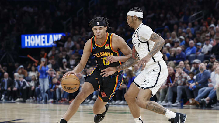 Jan 19, 2025; Oklahoma City, Oklahoma, USA; Oklahoma City Thunder forward Ousmane Dieng (13) drives around Brooklyn Nets guard Keon Johnson (45) during the second half at Paycom Center. Mandatory Credit: Alonzo Adams-Imagn Images Jan 19, 2025; Oklahoma City, Oklahoma, USA; Oklahoma City Thunder forward Ousmane Dieng (13) drives around Brooklyn Nets guard Keon Johnson (45) during the second half at Paycom Center. Mandatory Credit: Alonzo Adams-Imagn Images
