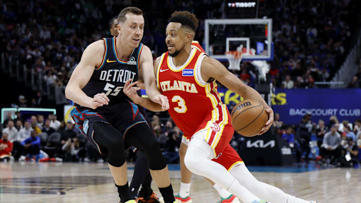 Mar 25, 2026; Detroit, Michigan, USA;  Atlanta Hawks guard CJ McCollum (3) dribbles defended by Detroit Pistons forward Duncan Robinson (55) in the second half at Little Caesars Arena. Mandatory Credit: Rick Osentoski-Imagn Images