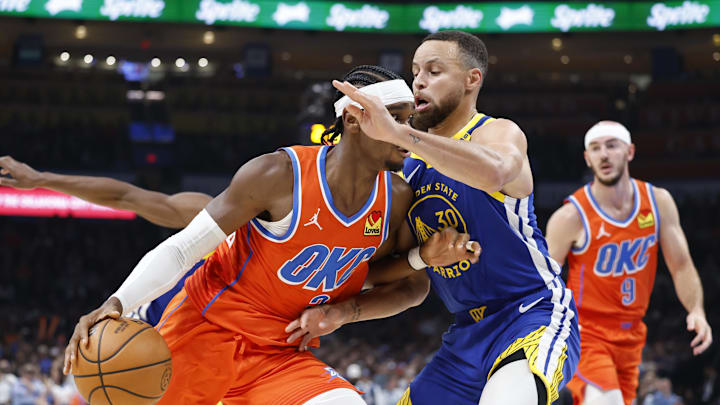 Oklahoma City Thunder guard Shai Gilgeous-Alexander (2) drives to the basket against Golden State Warriors guard Stephen Curry (30) during the second quarter at Paycom Center. Mandatory Credit: Alonzo Adams-Imagn Images