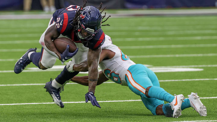 Aug 19, 2023; Houston, Texas, USA; Houston Texans running back Mike Boone (22) is tackled by Miami Dolphins cornerback Jamal Perry (46) in the fourth quarter at NRG Stadium. Mandatory Credit: Thomas Shea-Imagn Images