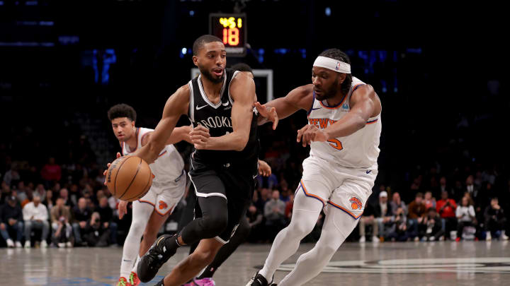 Jan 23, 2024; Brooklyn, New York, USA; Brooklyn Nets forward Mikal Bridges (1) drives to the basket against New York Knicks guard Quentin Grimes (6) and forward Precious Achiuwa (5) during the fourth quarter at Barclays Center. Mandatory Credit: Brad Penner-USA TODAY Sports