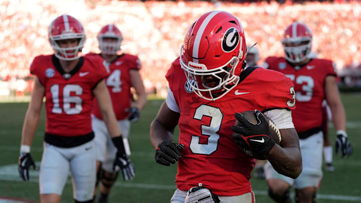 Georgia running back Nate Frazier (3) celebrates with his teammates after scoring touchdown during the second half of a NCAA college football game against Massachusetts in Athens, Ga., on Saturday, Nov. 23, 2024.