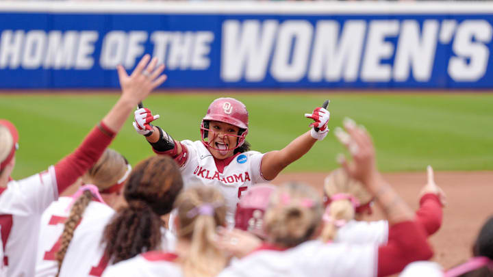 OU's Ella Parker (5) celebrates with her teammates after hitting a home run in the first inning against Tennessee during the Women's College World Series on Thursday, May 29, 2025, at Devon Park in Oklahoma City. OU's Ella Parker (5) celebrates with her teammates after hitting a home run in the first inning against Tennessee during the Women's College World Series on Thursday, May 29, 2025, at Devon Park in Oklahoma City.