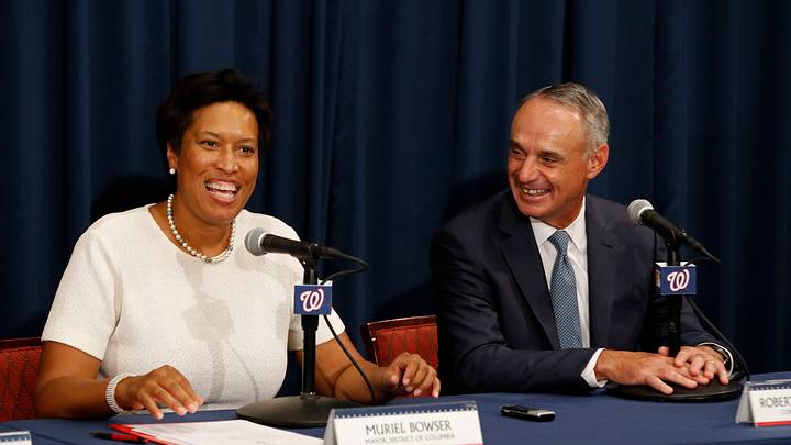 Jul 26, 2017; Washington, DC, USA; Washington DC mayor Muriel Bowser (L) speaks as MLB commissioner Robert D. Manfred, Jr (R) listens during a press conference to unveil the official logo for the 2018 All-Star Game prior to the game between the Washington Nationals and the Milwaukee Brewers at Nationals Park. Mandatory Credit: Geoff Burke-USA TODAY Sports