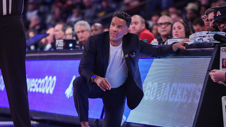 Feb 12, 2025; Atlanta, Georgia, USA; Georgia Tech Yellow Jackets head coach Damon Stoudamire kneels on the sideline against the Stanford Cardinal in the first half at McCamish Pavilion. Mandatory Credit: Brett Davis-Imagn Images