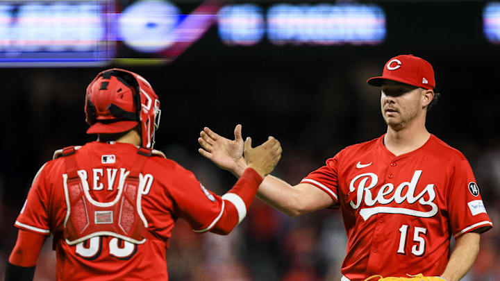 Apr 12, 2025; Cincinnati, Ohio, USA; Cincinnati Reds relief pitcher Emilio Pagan (15) shakes hands with catcher Jose Trevino (35) after the victory over the Pittsburgh Pirates at Great American Ball Park. Mandatory Credit: Katie Stratman-Imagn Images