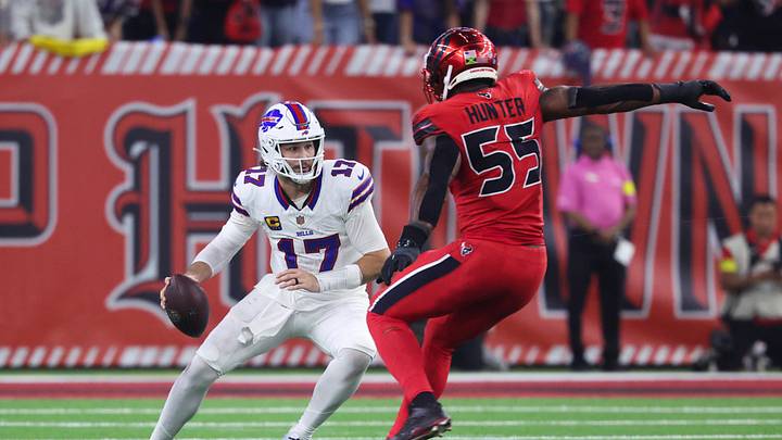 Nov 20, 2025; Houston, Texas, USA; Buffalo Bills quarterback Josh Allen (17) runs with the ball as Houston Texans defensive end Danielle Hunter (55) applies defensive pressure during the second half at NRG Stadium. Mandatory Credit: Troy Taormina-Imagn Images