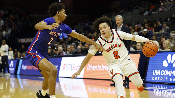Dec 22, 2025; Charlottesville, Virginia, USA; Virginia Cavaliers guard Chance Mallory (2) drives to the basket as American University Eagles guard Madden Collins (2) defends in the second half at John Paul Jones Arena. Mandatory Credit: Geoff Burke-Imagn Images