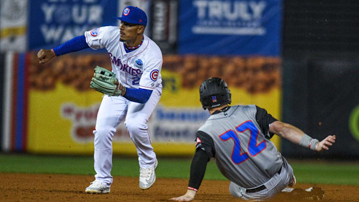 Rocket City Trash Pandas' right fielder Tucker Flint (22) slides into second base during the last opening day game at the Tennessee Smokies Stadium on Friday, April 5, 2024 in Kodak, Tenn.