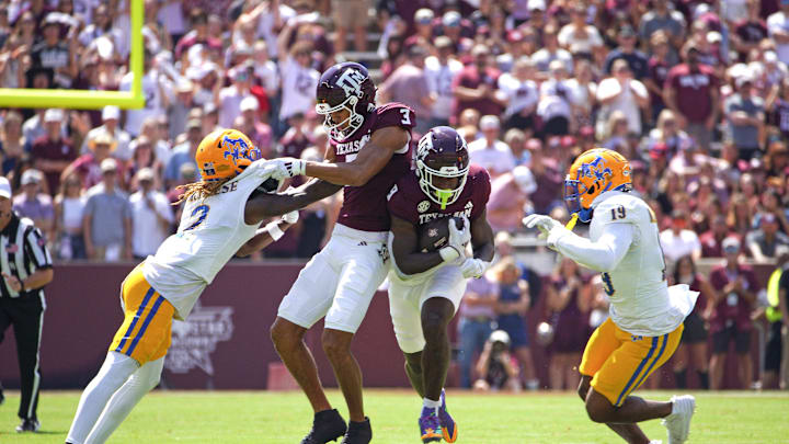 Sep 7, 2024; College Station, Texas, USA; Texas A&M Aggies running back Le'Veon Moss (8) runs the ball while wide receiver Noah Thomas (3) blocks McNeese State Cowboys defensive back Levi Wyatt (2) during the first quarter at Kyle Field. Mandatory Credit: Dustin Safranek-Imagn Images