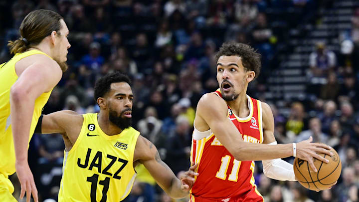 Feb 3, 2023; Salt Lake City, Utah, USA; Atlanta Hawks guard Trae Young (11) dribbles around Utah Jazz guard Mike Conley (11) and forward/center Kelly Olynyk (41) during the first half at Vivint Arena. Mandatory Credit: Christopher Creveling-Imagn Images