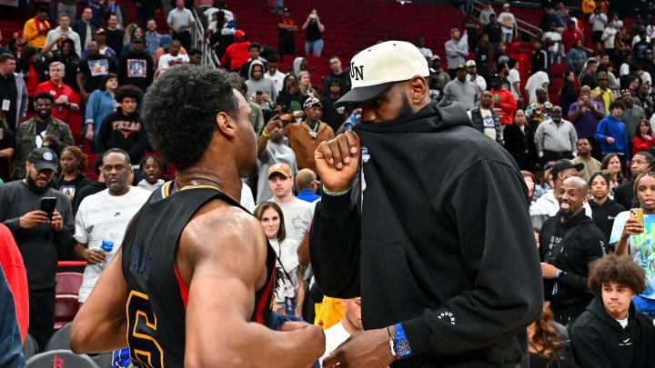 Mar 28, 2023; Houston, TX, USA; McDonald's All American West guard Bronny James (6) speaks with his father, LeBron James of the Los Angeles Lakers, after the game against the McDonald's All American East at Toyota Center. Mandatory Credit: Maria Lysaker-USA TODAY Sports