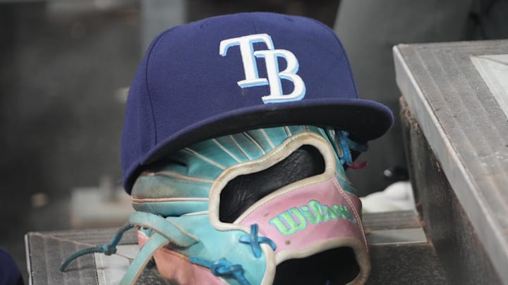 Sep 26, 2025; Toronto, Ontario, CAN; The hat and glove of Tampa Bay Rays third baseman Junior Caminero (13) in the dugout during the game against the Toronto Blue Jays at Rogers Centre. 